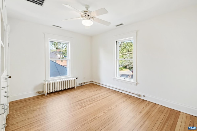 410 Altamont Cir, Charlottesville, VA 22902 - empty room featuring radiator, visible vents, a wealth of natural light, and light wood-type flooring