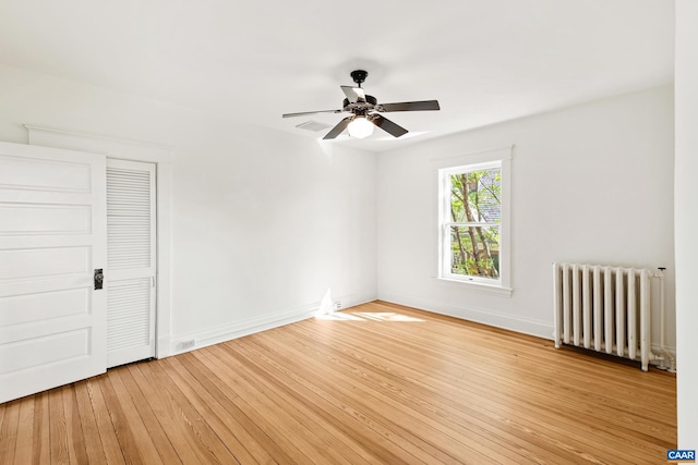 410 Altamont Cir, Charlottesville, VA 22902 - unfurnished bedroom featuring radiator heating unit, a ceiling fan, light wood-style flooring, and baseboards