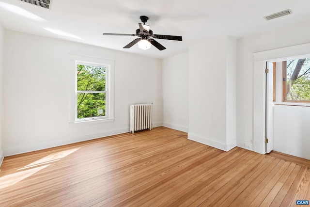 410 Altamont Cir, Charlottesville, VA 22902 - spare room with visible vents, radiator heating unit, light wood-style flooring, and plenty of natural light