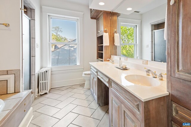 410 Altamont Cir, Charlottesville, VA 22902 - bathroom featuring double vanity, a sink, a shower stall, and radiator
