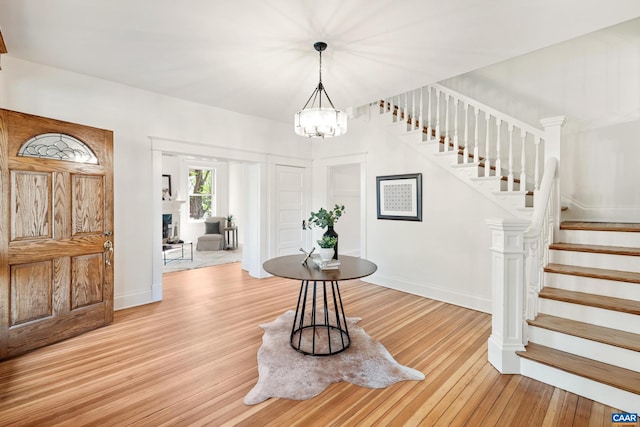 410 Altamont Cir, Charlottesville, VA 22902 - entrance foyer with stairway, a chandelier, light wood finished floors, and baseboards