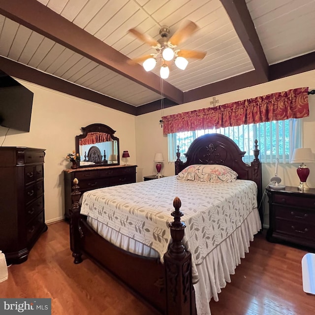 bedroom with beam ceiling, wood finished floors, a ceiling fan, and wood ceiling