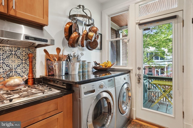 laundry area featuring separate washer and dryer and cabinet space