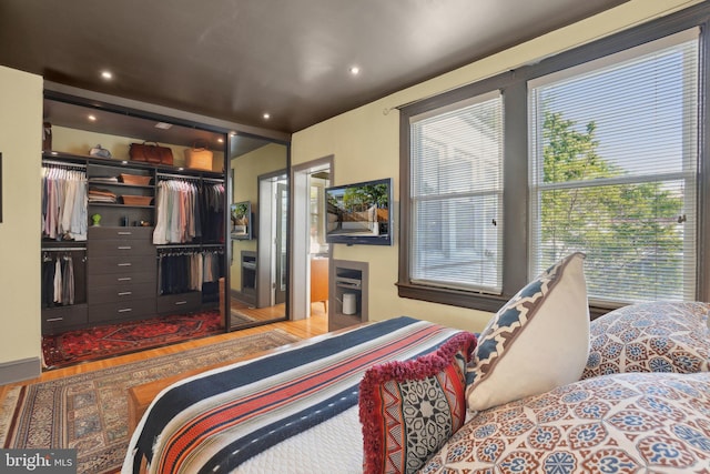 bedroom with recessed lighting and wood finished floors