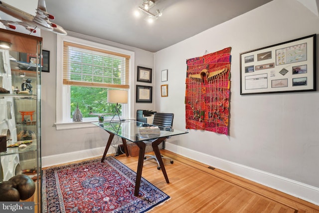 office with baseboards and wood finished floors