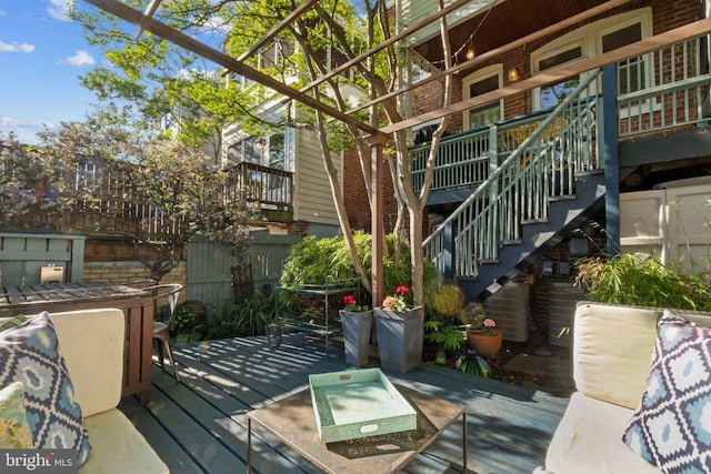 wooden terrace with fence, central AC unit, and stairs