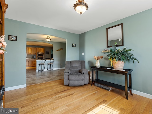 2004 State Road 259 N, Wardensville, WV 26851 - living area with arched walkways, baseboards, and light wood finished floors
