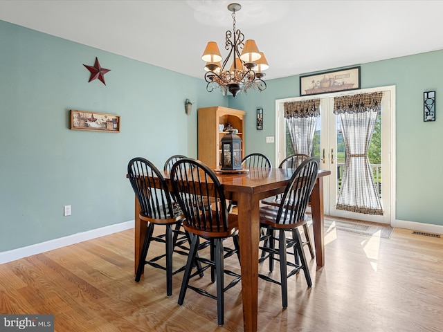 2004 State Road 259 N, Wardensville, WV 26851 - dining room featuring french doors, visible vents, wood finished floors, baseboards, and a notable chandelier