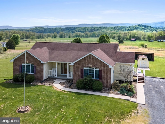 2004 State Road 259 N, Wardensville, WV 26851 - view of front facade featuring a porch, a front lawn, a mountain view, and brick siding