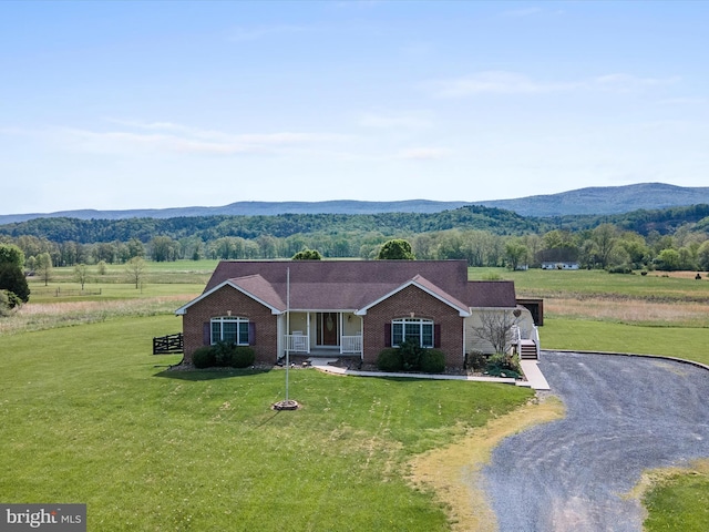 2004 State Road 259 N, Wardensville, WV 26851 - view of front of house with a porch, a front lawn, a mountain view, and brick siding