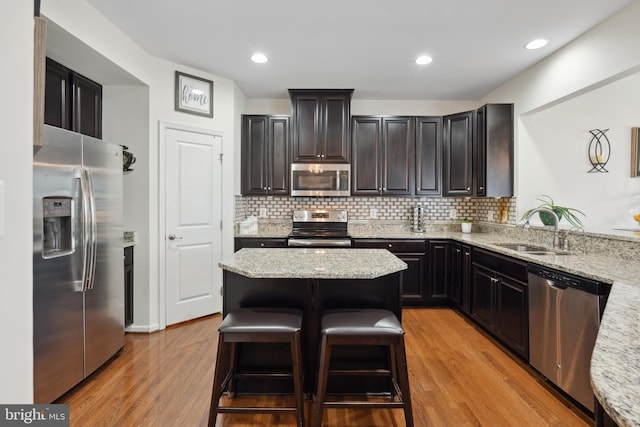 155 Tollerton Trl, Falling Waters, WV 25419 - kitchen featuring appliances with stainless steel finishes, a sink, light wood-style floors, decorative backsplash, and recessed lighting
