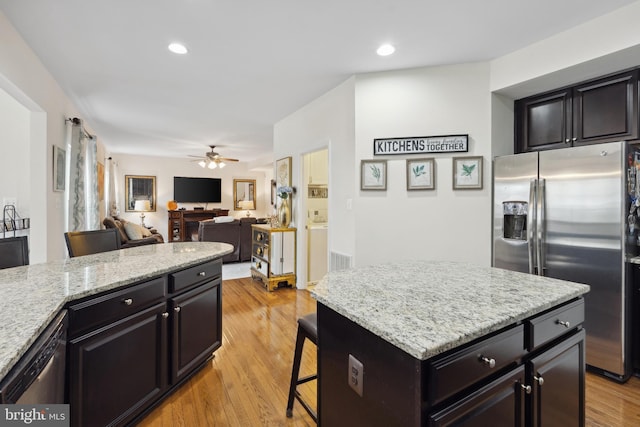 155 Tollerton Trl, Falling Waters, WV 25419 - kitchen with appliances with stainless steel finishes, ceiling fan, light stone counters, a kitchen breakfast bar, and recessed lighting