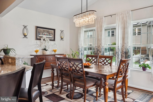 155 Tollerton Trl, Falling Waters, WV 25419 - dining area with wood finished floors, a chandelier, and baseboards
