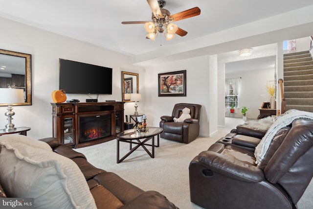 155 Tollerton Trl, Falling Waters, WV 25419 - living area featuring stairway, carpet floors, a ceiling fan, and a glass covered fireplace