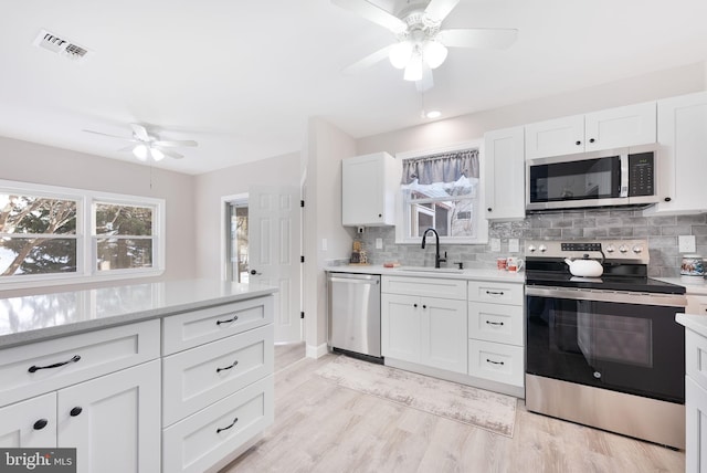 5 Greenmeadow Ln, Whiting, NJ 08759 - kitchen with stainless steel appliances, backsplash, visible vents, a sink, and ceiling fan