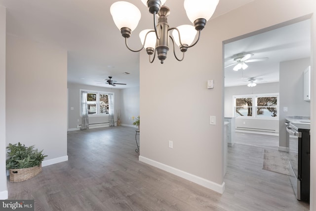 5 Greenmeadow Ln, Whiting, NJ 08759 - unfurnished dining area with a baseboard radiator, light wood-style floors, baseboards, and ceiling fan with notable chandelier