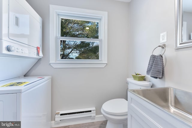 5 Greenmeadow Ln, Whiting, NJ 08759 - half bathroom featuring stacked washer / drying machine, a baseboard radiator, toilet, and a sink