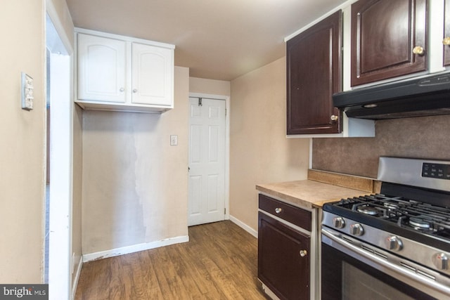 kitchen with dark brown cabinets, baseboards, white cabinets, stainless steel range with gas cooktop, and under cabinet range hood