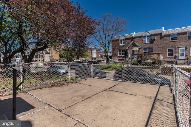 view of patio / terrace with fence, a residential view, and a gate