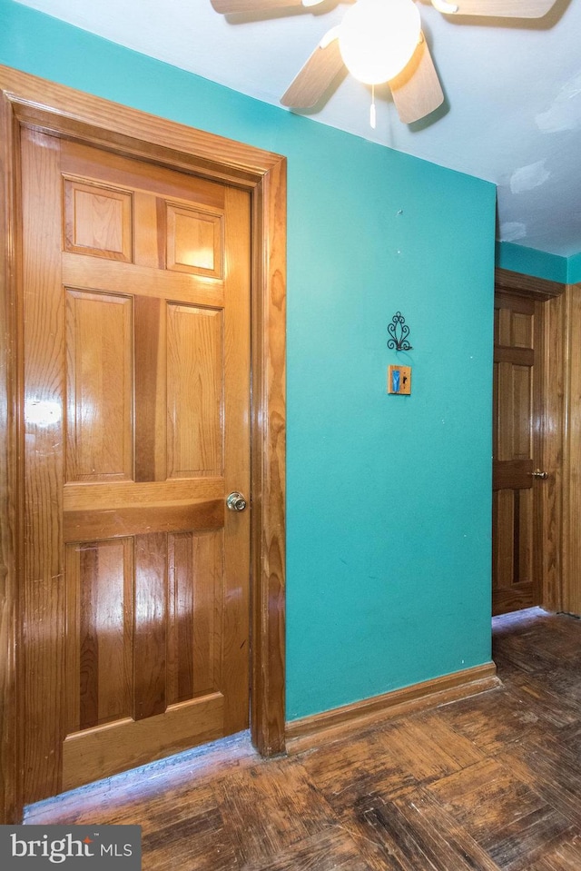 interior space featuring ceiling fan and baseboards