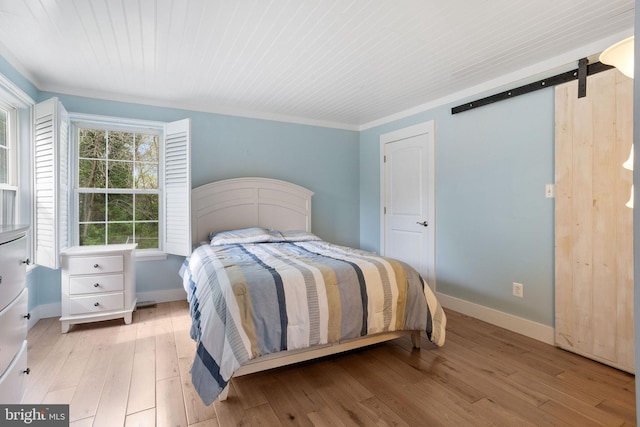 bedroom featuring baseboards and light wood-style floors