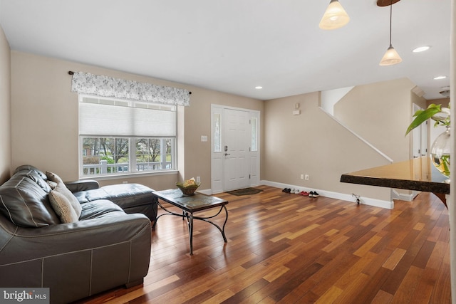 living room with wood finished floors, recessed lighting, and baseboards
