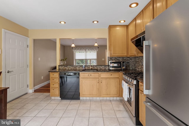 kitchen with light tile patterned floors, a sink, appliances with stainless steel finishes, dark countertops, and backsplash
