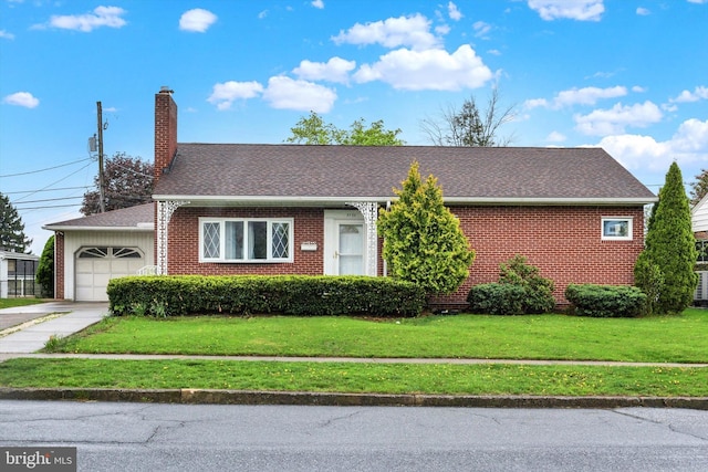 single story home with a front yard, a chimney, a garage, and brick siding