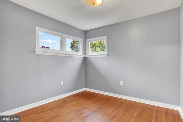 empty room featuring light wood-style floors and baseboards