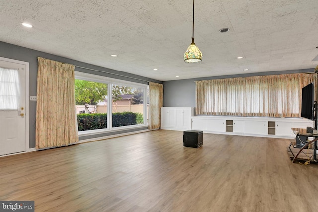 unfurnished living room featuring recessed lighting and wood finished floors