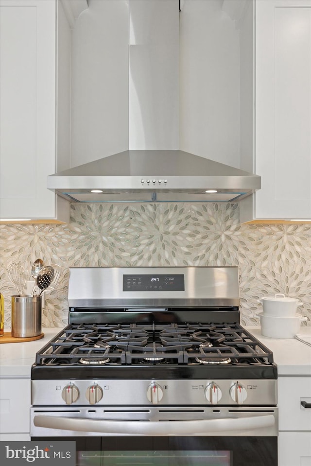 800 Erlen Rd, Plymouth Meeting, PA 19462 - kitchen with white cabinets, backsplash, wall chimney exhaust hood, and gas range