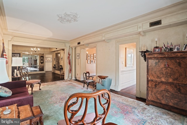 3901 Connecticut Ave NW Unit 402, Washington, DC 20008 - living room with crown molding, a chandelier, and wood finished floors