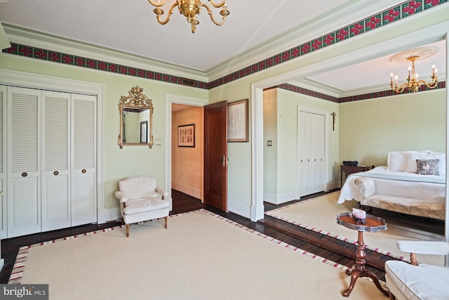3901 Connecticut Ave NW Unit 402, Washington, DC 20008 - bedroom featuring a closet, wood finished floors, ornamental molding, baseboards, and a notable chandelier