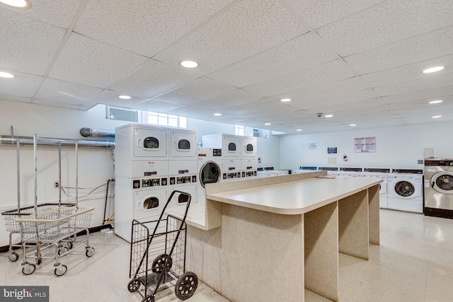 3901 Connecticut Ave NW Unit 402, Washington, DC 20008 - kitchen featuring washer and clothes dryer, stacked washing maching and dryer, a paneled ceiling, and visible vents