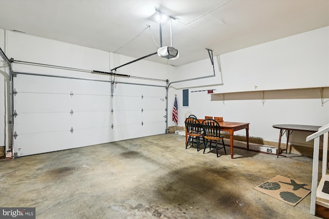 garage featuring electric panel and a garage door opener
