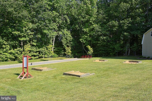 view of property's community with a lawn