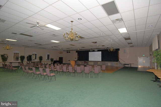 misc room featuring visible vents, a notable chandelier, and carpet flooring