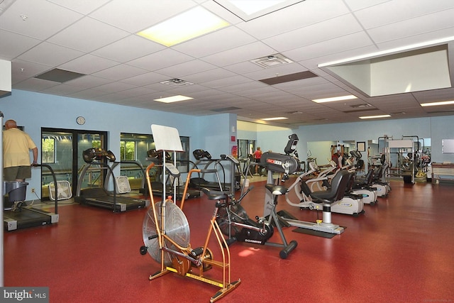 exercise room featuring visible vents and a drop ceiling