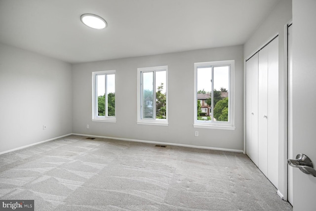 2456 Sun Valley Cir Unit 7-M, Silver Spring, MD 20906 - unfurnished bedroom with a closet, visible vents, baseboards, and light carpet