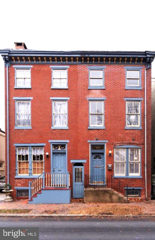 412 Market St, Trenton, NJ 08611 - view of front facade with a chimney and brick siding