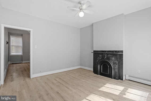 412 Market St, Trenton, NJ 08611 - unfurnished living room with wood finished floors, a baseboard heating unit, a fireplace, baseboards, and a ceiling fan