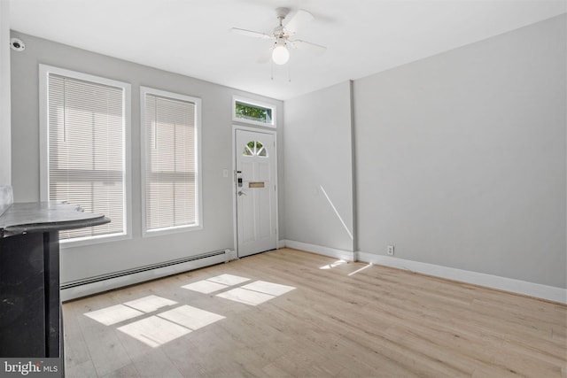 412 Market St, Trenton, NJ 08611 - foyer featuring a baseboard heating unit, ceiling fan, wood finished floors, and baseboards