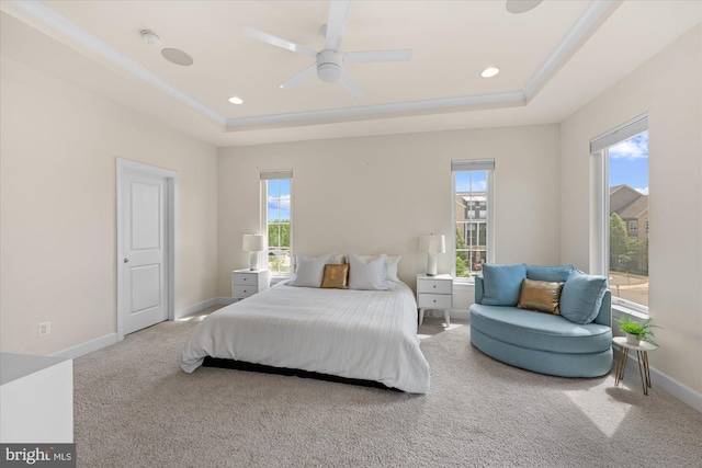bedroom featuring a tray ceiling, carpet, baseboards, recessed lighting, and ceiling fan