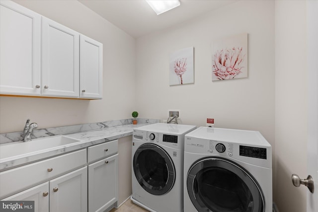 clothes washing area featuring cabinet space and independent washer and dryer