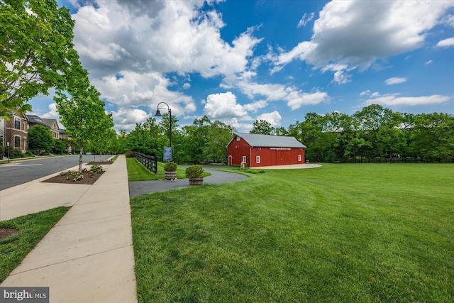 view of yard with a barn and an outbuilding
