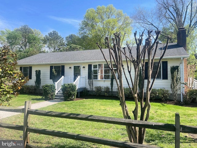 single story home with fence private yard, a chimney, and a front lawn
