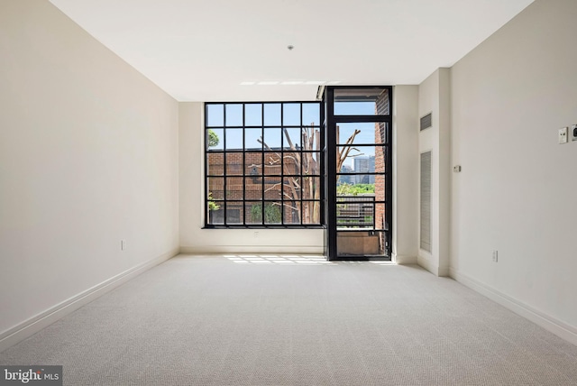 unfurnished room with baseboards and carpet flooring