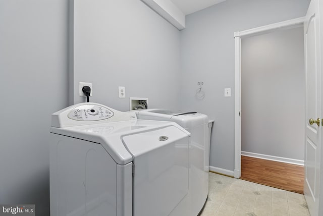 42827 Freedom St, Chantilly, VA 20152 - laundry area featuring washer and clothes dryer, light tile patterned floors, and baseboards