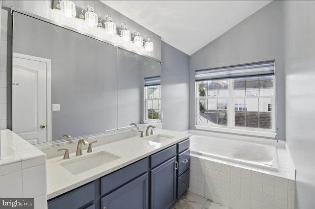 42827 Freedom St, Chantilly, VA 20152 - bathroom featuring vaulted ceiling, double vanity, a bath, and marble look tile flooring