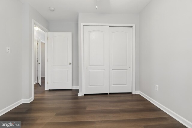 42827 Freedom St, Chantilly, VA 20152 - unfurnished bedroom featuring a closet, baseboards, and dark wood-style flooring